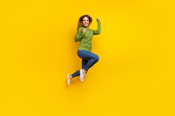 Fototapeta na wymiar Full size photo of delighted satisfied person raise fists jumping isolated on yellow color background