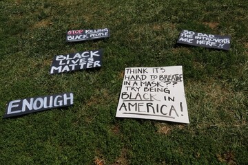 Black Lives Matter posters on the green lawn in the park