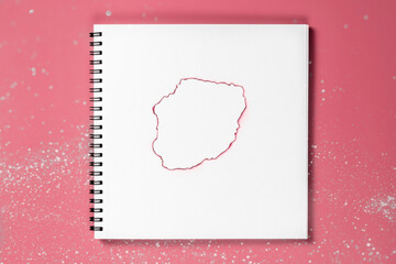 White notebook with burnt page. A blank layout template of spiral notebook on pink background.