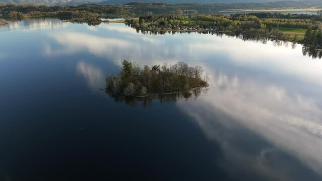 Aerial view, Staffelsee with islands, Garmisch Partenkirchen region, Bavaria, Germany near Murnau in sunny weather at sunset in spring. Drone view over islands of a large beautiful lake in Bayern. 