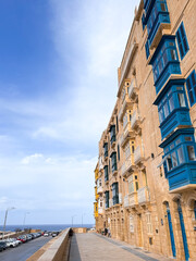 Old historical buildings in the island Malta, Valletta town, beautiful stone walls and colorful balcony, nice weather