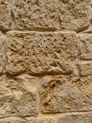 Old stone wall texture with pores and sand