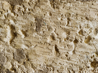 Old stone wall texture with pores and sand