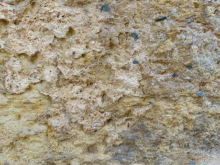 Old stone wall texture with pores and sand