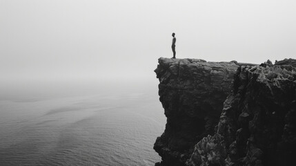 Standing atop a cliff facing a vast black ocean a lone Black man gazes out into the unknown transfixed by the haunting beauty of this dark paradise. . - obrazy, fototapety, plakaty