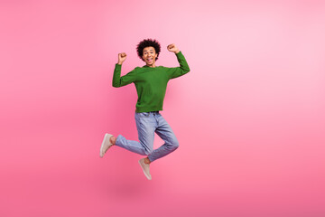 Photo of positive cheerful guy jump up with raise fists up winning isolated pastel color background