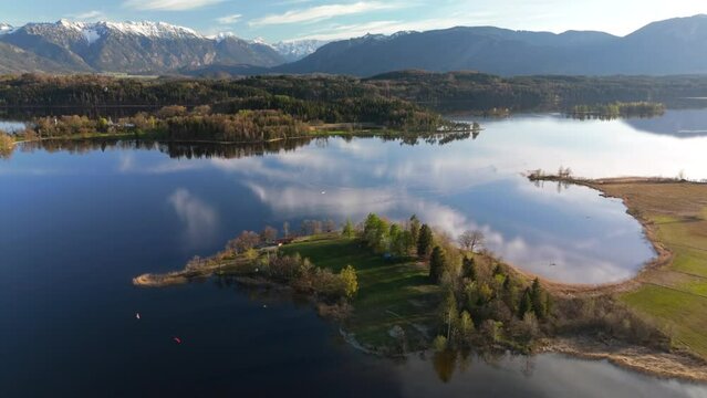 Aerial view, Staffelsee with islands, Garmisch Partenkirchen region, Bavaria, Germany near Murnau in sunny weather at sunset in spring. Drone view over islands of a large beautiful lake in Bayern. 