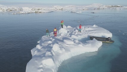 In the tranquil, icy waters of Antarctica, a team of explorers gathers on a floating ice floe,...