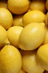 Fresh lemons as background, closeup. Citrus fruit