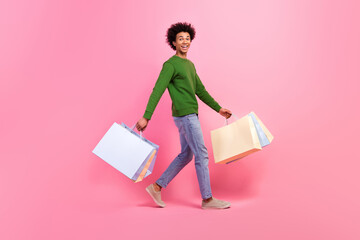 Photo of happy excited guy walk buy many purchase shopping bags isolated pastel color background