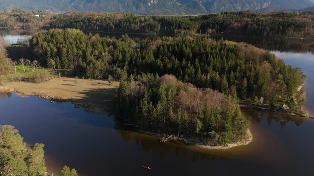 Aerial view, Staffelsee with islands, Garmisch Partenkirchen region, Bavaria, Germany near Murnau in sunny weather at sunset in spring. Drone view over islands of a large beautiful lake in Bayern. 