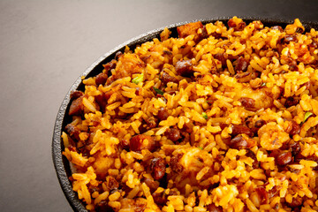 Baião de Dois traditional Brazilian food with rice, beans, sausage and rennet cheese close up