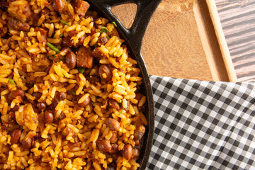 Baião de Dois traditional Brazilian food with rice, beans, sausage and rennet cheese close up