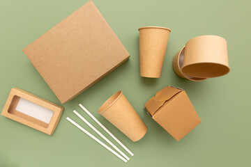 Eco-friendly food packaging for food on a green background. View from above.