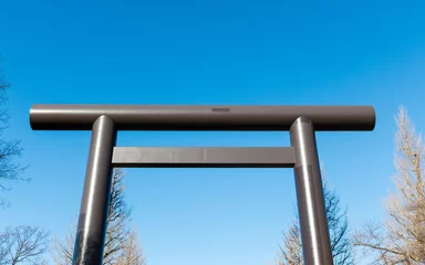 Afwasbaar fotobehang A big grey torii gate with blue sky. © AlexandraDaryl