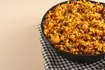 Baião de Dois traditional Brazilian food with rice, beans, sausage and rennet cheese close up