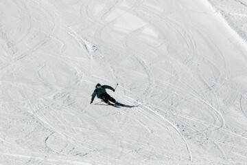 Skier skiing in the Swiss alps off-piste in white snow