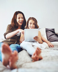 Funny, mother and child on tablet in bed at home together for game, relax and family streaming...