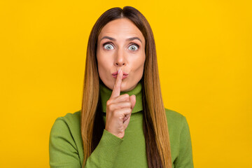 Portrait of pretty lady finger covering close lips do not tell look camera isolated on yellow color...