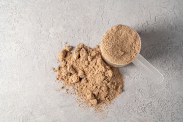 Protein powder in scoop. Food supplement, bodybuilding, fitness and sport