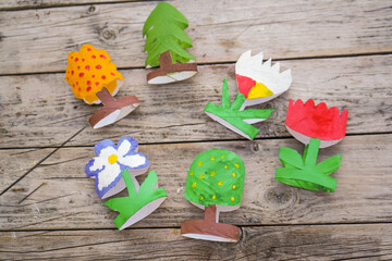 Kids craft trees and flowers out of recycling toilet paper roll, zero waste concept.