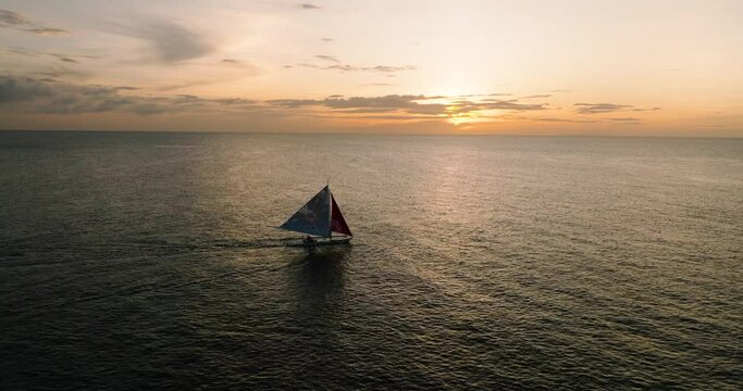 Beautiful landscape of paraw private sailing boat with sunset background in Boracay, Philippines.
