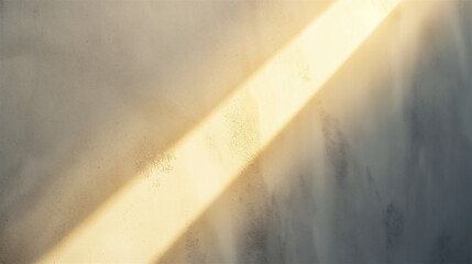 Sun rays shining casting shadows on an textured yellow beige wall