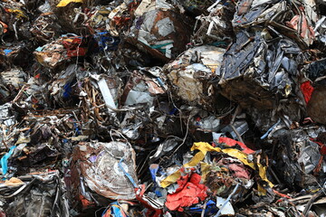 Heavy Melting Steel (HMS) bundle scrap consists of discarded steel and wrought iron items, grouped together in bundles, ready for processing and repurposing