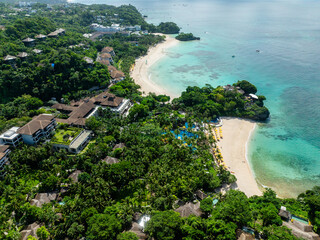 Tropical beach resorts with sun reflection on white sand and turquoise waters. Boracay, Philippines.