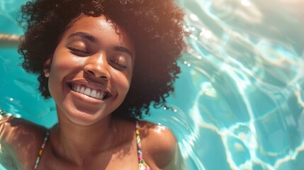 Black woman in vibrant swimsuit smiles while relaxing in turquoise pool water