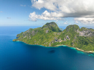 Cadlao Island surrounded by blue sea, blue sky and clouds. El Nido, Palawan. Philippines.