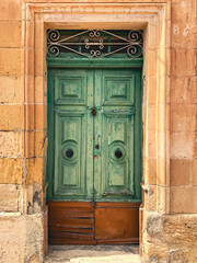 a green door  in the old historical building in the island of the malta