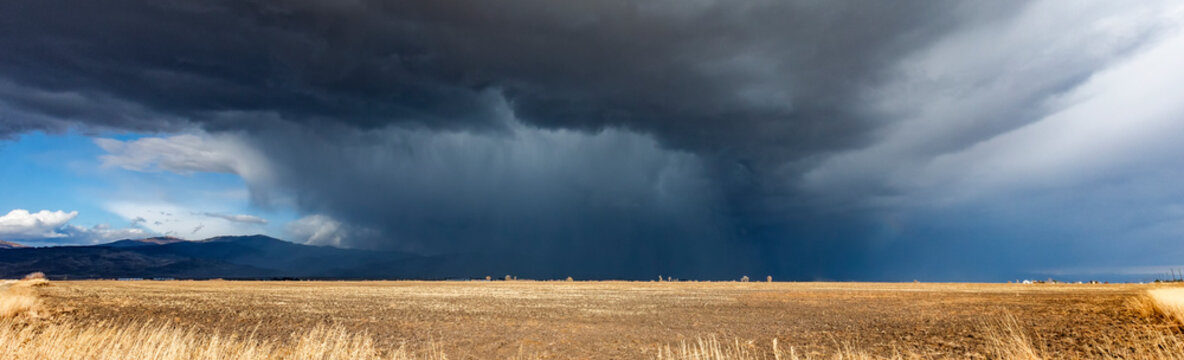 Dramatic storm clouds over field