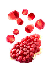 Cut the pomegranate   isolated on white background. Levitation.