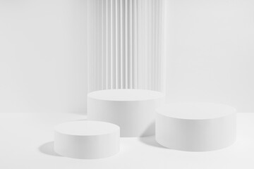 Three white round podiums with striped column as geometric decor, mockup on white background. Template for presentation cosmetic products, gifts, goods, advertising in contemporary black friday style. - 787243363