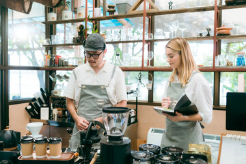 barista talking with customer about tasted of coffee cup with happy emotion at counter bar at...