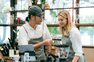 barista talking with customer about tasted of coffee cup with happy emotion at counter bar at...