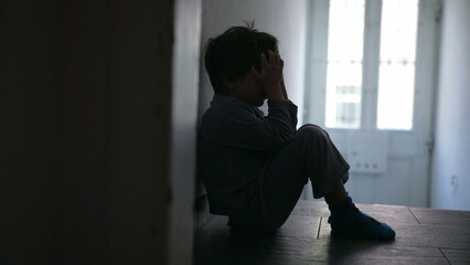 Young Child Experiencing Family Crisis, Sitting Solitarily in Poorly Lit Hallway, Covering Face...