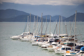 speedboats arranged side by side on a pier in the sea