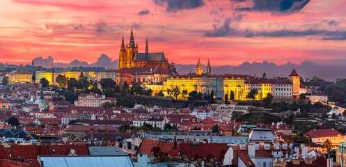 The aerial view of UNESCO site Prague cityscape of downtown and the illuminated castle and the St. Vitus Cathedral in colorful twilight.