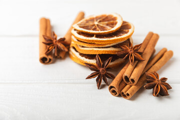 Cinnamon sticks and anise on a textured background. Cinnamon roll and star anise. Spicy spice for baking, desserts and drinks. Fragrant ground cinnamon.Place for text. copy space.