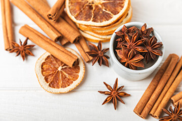 Obraz na płótnie Canvas Cinnamon sticks and anise on a textured background. Cinnamon roll and star anise. Spicy spice for baking, desserts and drinks. Fragrant ground cinnamon.Place for text. copy space.