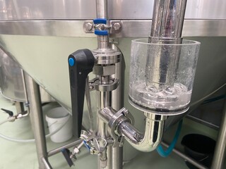 Pressure gauge on the pipe of craft brewing equipment in a brewery. Pressure adjusting apparatus...