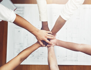 Hands stack, teamwork and architecture planning with blueprint for design meeting, collaboration or...