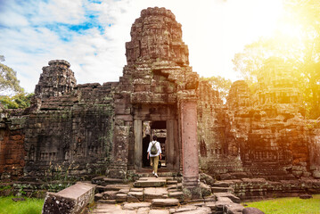 Female tourist walking to ancient Angkor temple in Cambodia - 787258341