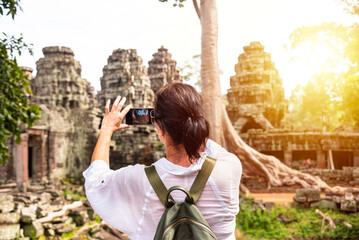 Female tourist taking photo of ancient Angkor temple in Cambodia - 787258764