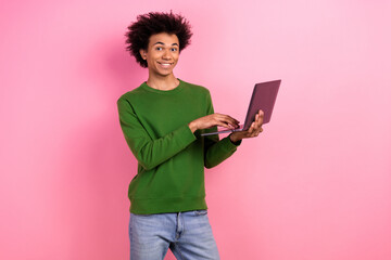 Photo of happy positive guy using netbook for coworking isolated pastel color background