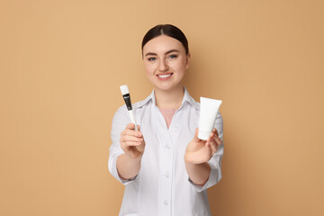 Cosmetologist with cosmetic product and brush on beige background