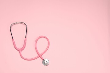 Obraz na płótnie Canvas Stethoscope on pink background, top view. Space for text
