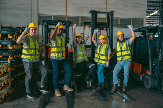 In a factory setting, a team of engineers and foremen emphasize safety and teamwork during a meeting, ensuring success in the construction industry.